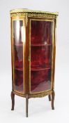A French Transitional style gilt metal mounted mahogany vitrine, of demi lune form with marble top