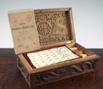 A bamboo and bone mahjong set, within a dragon carved Chinese box, together with another mahjong set