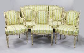 A suite of George III white and gilt seat furniture, comprising five armchairs and a settee, the