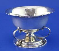 An Edwardian Art Nouveau Scottish silver circular pedestal bowl, with three scroll supports and