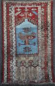 A Ladik prayer rug, with central mihrab on a red and ivory ground with stylised flowers and six