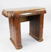 An Art Deco burr walnut serving table, the deep shaped frieze with floral carved corner motifs, on a