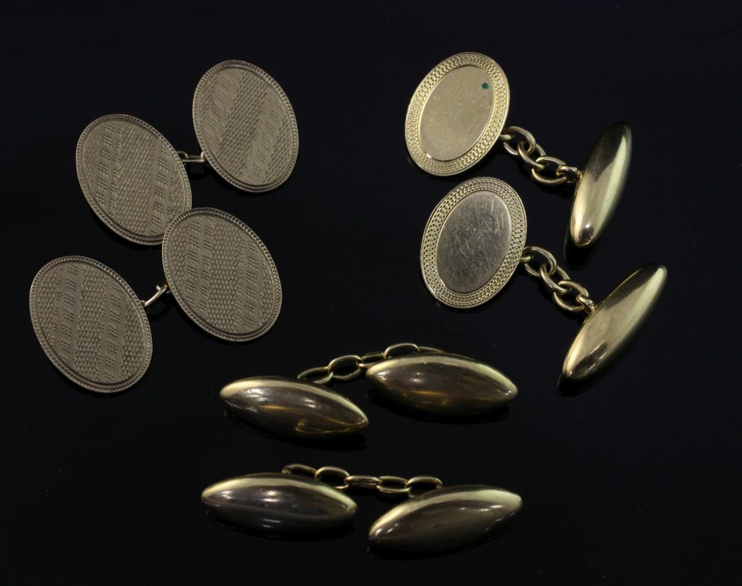 A pair of early 20th century 18ct gold oval cufflinks with engine turned border and two other