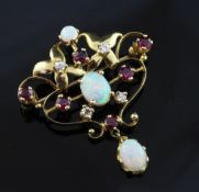 A 1970's Art Nouveau style 18ct gold, white opal, ruby and diamond set open scrollwork pendant