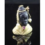 A 20th century 18ct gold, ruby, carved obsidian? and cultured pearl brooch modelled as the bust of