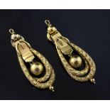 A pair of Victorian gold drop earrings, of engraved double loop and buckle design, (lacking ear