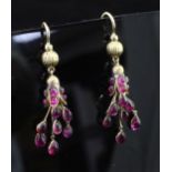 A pair of early 20th century gold and ruby drop earrings, each set with fifteen rubies including