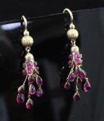 A pair of early 20th century gold and ruby drop earrings, each set with fifteen rubies including