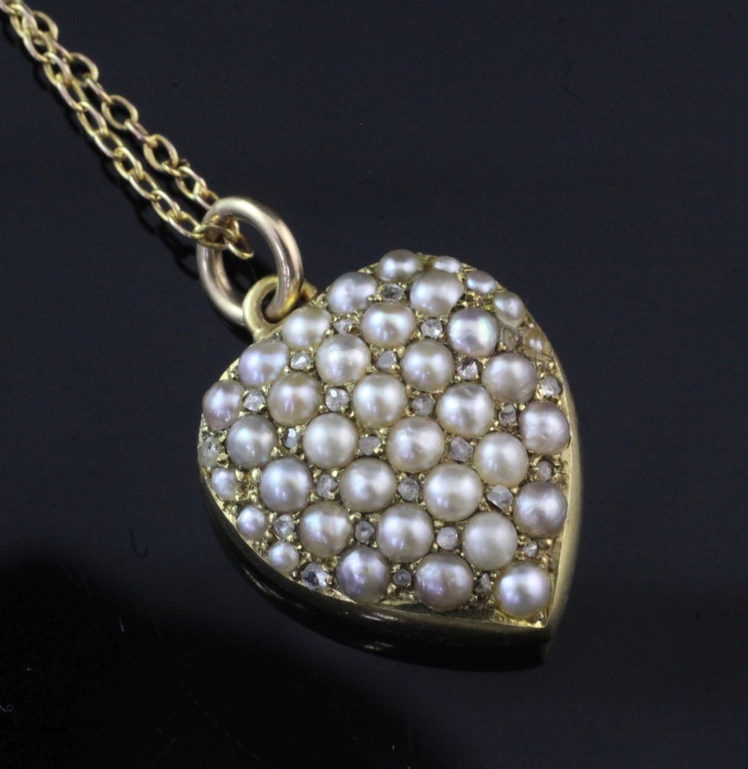 A Victorian 15ct gold, split pearl and diamond set heart shaped pendant locket, pendant (glazed