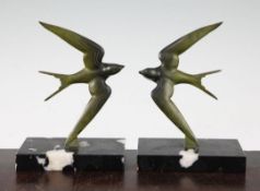 A pair of French patinated bronze swallow bookends, signed G.Garreau, on rectangular marble bases,