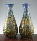 A pair of large C. H. Brannam pottery baluster vases, c.1902, each incised and relief decorated in