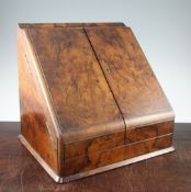 A Victorian walnut stationery cabinet, the sloping pair of doors opening to reveal a lift-out