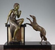 A French Art Deco patinated metal figure group, modelled as a stylish young woman with attendant
