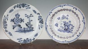 Two Delft blue and white chargers, 18th century, the first painted with an egret, rockwork and