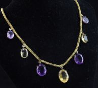 A gold, amethyst and citrine necklace, set with seven graduated stones on a fancy cannetile work