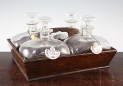 A set of four shaped glass decanters and stoppers, with an oak carrier 19th century, Continental,
