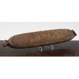 A Maori feather box, Wakahuia, with all over carved scrollwork decoration with tiki mask ends, 14.