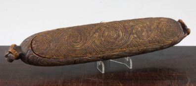 A Maori feather box, Wakahuia, with all over carved scrollwork decoration with tiki mask ends, 14.