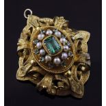 A Victorian gold, emerald and split pearl set oval brooch, with engraved pierced scroll mount and
