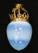 A large ovoid vaseline glass pendant shade, with a pierced scrolling gothic gilded brass fitting,