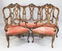 An 18th century style Venetian five piece walnut salon suite, includes a three seat settee and