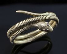 An early 1960's Victorian style 9ct gold coiled serpent bracelet, with engraved decoration and