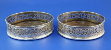 A pair of George III pierced silver wine coasters by Richard Morton & Co, with engraved armorial and