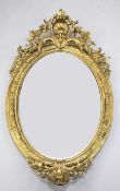 A 19th century French oval gilt gesso wall mirror, with pierced scrolling crest, central shell motif