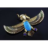 An Egyptian revival gold, plique a jour, turquoise and lapis lazuli winged falcon brooch with the
