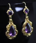 A pair of Victorian style gold and amethyst drop earrings, each with scrolling borders and set