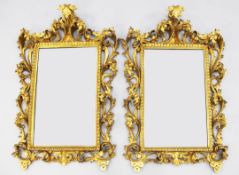 A pair of 19th century Florentine gilt wall mirrors, each with rectangular plate glass and pierced