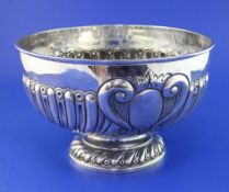 A late Victorian demi-spiral fluted silver presentation rose bowl by Goldsmiths & Silversmiths Co