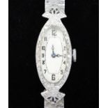 A lady's late 1920's 18ct white gold and diamond set cocktail watch, with oval Arabic dial, on a