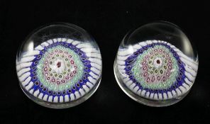A pair of English millefleur magnum paperweights, mid 19th century, with concentric cane rods, 9.