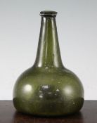 A Dutch green glass onion shaped wine bottle, early 18th century, with applied rim and high-kicked