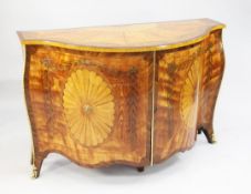 A George III style satinwood and marquetry serpentine commode, in the style of John Cobb, the top