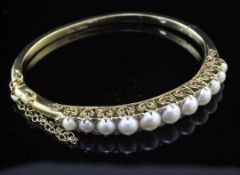 A Victorian style 9ct gold, graduated split cultured pearl and diamond set hinged bangle, with