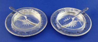 A pair of George V pierced silver butter dishes, of circular form with gadrooned borders and star