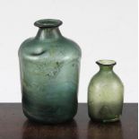 Two Roman glass bottles, c.2nd-4th century AD, the largest with a dimple to the shoulder and mineral