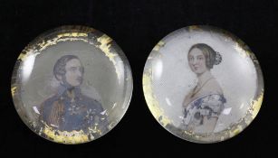 A pair of English reverse painted glass paperweights, circa 1850, with a portrait of Queen