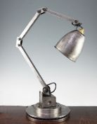 An Industrial angle poise lamp, on stepped circular base, base 9in.