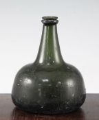 An English dark green glass onion shaped wine bottle, early 18th century, with applied rim to the