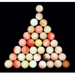 A collection of thirty seven ivory snooker balls, with traces of original colour staining, each ball