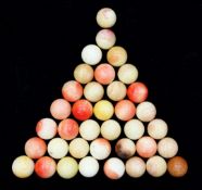 A collection of thirty seven ivory snooker balls, with traces of original colour staining, each ball