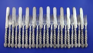 Twelve pairs of Victorian ornate silver dessert eaters, with spiral twist foliate decorated handles,