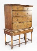 A William & Mary style walnut and marquetry inlaid chest on stand, the front decorated with birds