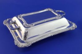 A 1940's silver entree dish and cover, with gadrooned borders and shell, scroll corners, Gladwin