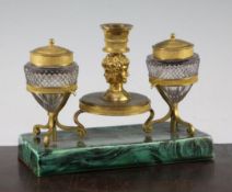 A 19th century French ormolu and cut glass inkstand, with ages of man cast taperstick, now mounted