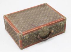 A Louis Vuitton travel case, brass bound with brown leather corners, locks marked LV and the key