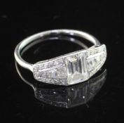 A 1930'/1940's white gold and diamond elliptical shaped ring, with central emerald cut diamond and